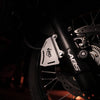 MotoCare silver caliper guard installed on Hero XPulse 210 protecting brake disc and caliper