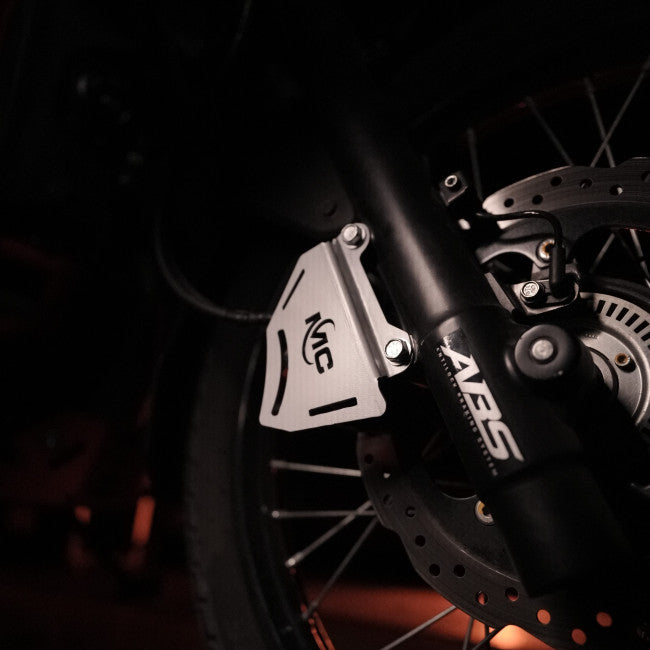 MotoCare silver caliper guard installed on Hero XPulse 210 protecting brake disc and caliper