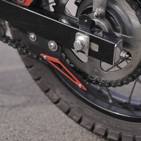 MotoCare red chain sprocket guard installed on Hero XPulse 210 protecting chain and sprocket system