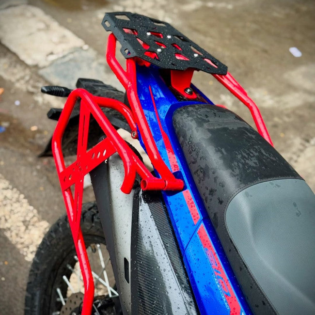 MotoCare red saddle stay installed on Hero XPulse 210 supporting saddlebags